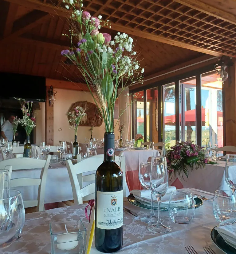 Tables set for guests with a bottle of Inalbi Chianti Classico